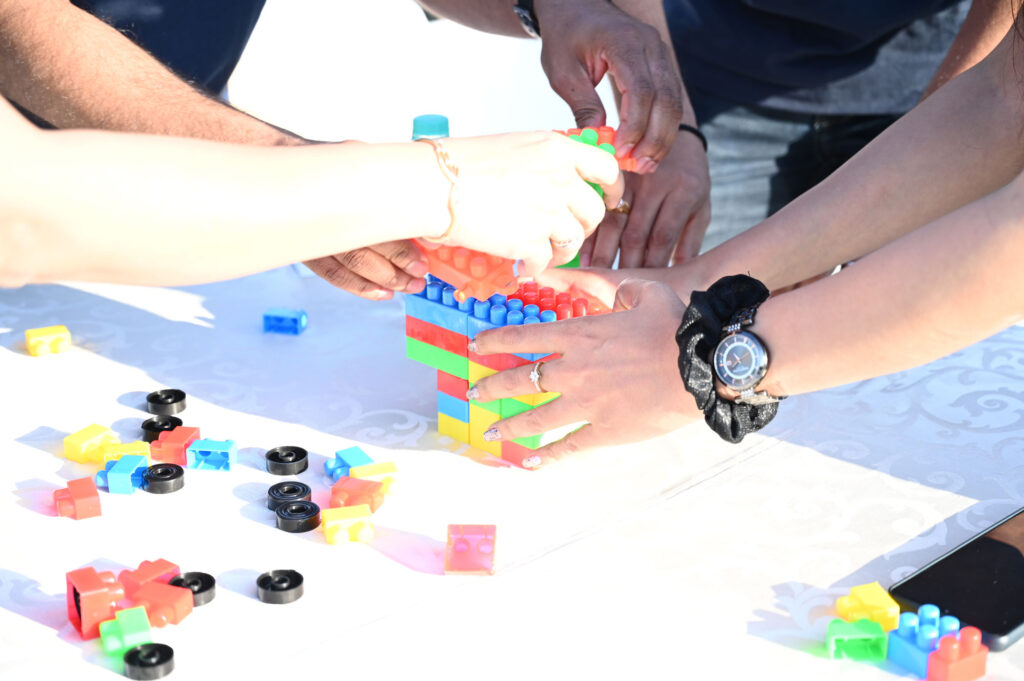 close-up of Livegage staff engaging in a block-building exercise